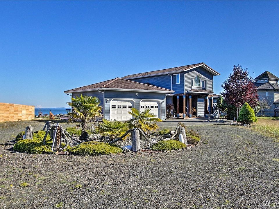 This spectacular bay front home boasts 95 feet of waterfront and views of Grays Harbor, Mt. Rainier & the Olympics from most rooms! Featuring one of the best locations in all of Ocean Shores nearby the Ocean Shores Community Club, Marina and Coastal Interpretive Center.  This approximate 1/3-acre lot boasts a circular driveway, a large rock bulkhead and gorgeous mature landscaping that includes many Chinese Fan Palms.  