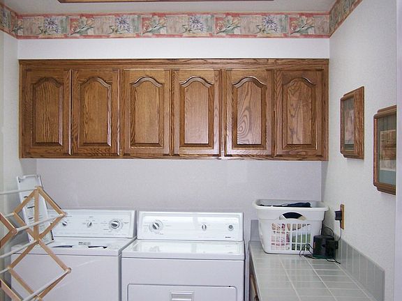 Large Indoor laundry room w/tile counter and many cabnets 
