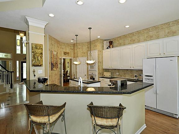 Spacious island kitchen features granite countertops and breakfast bar. Seller is upgrading all appl