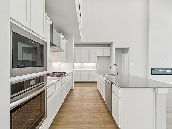 Kitchen in the Mercury home plan by Trophy Signature Homes - REPRESENTATIVE PHOTO