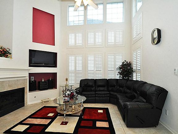 Soaring two story ceilings in family room with windows from floor to ceiling, and upgraded plantatio