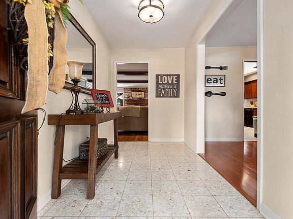 Bright foyer with tiled entry and updated lighting