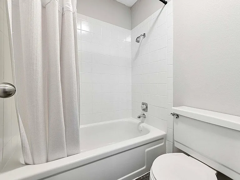 Explore the sleek elegance of this minimalist bathroom, blending comfort with style.