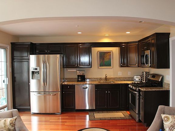 Open concept kitchen with new stainless steel appliances