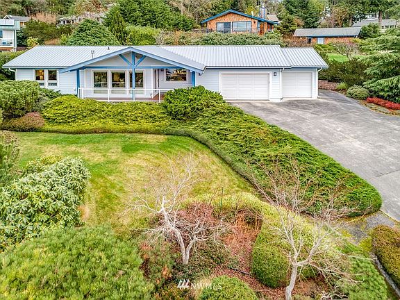 This well-maintained home has a great aging-in-place design, metal roof, lovely landscaping, and plenty of parking space for guests. 