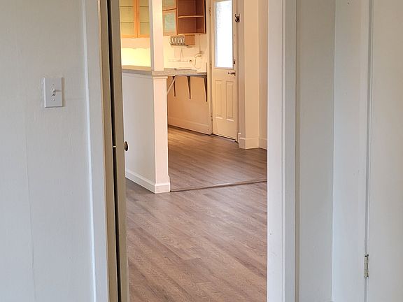 From the primary bedroom looking into the family room and the kitchen and front door are in the background.