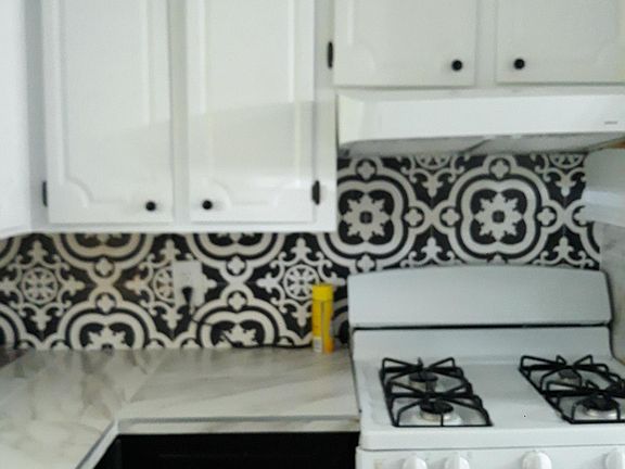 Black and White Kitchen, White porcelain counter tops and porcelain flooring.