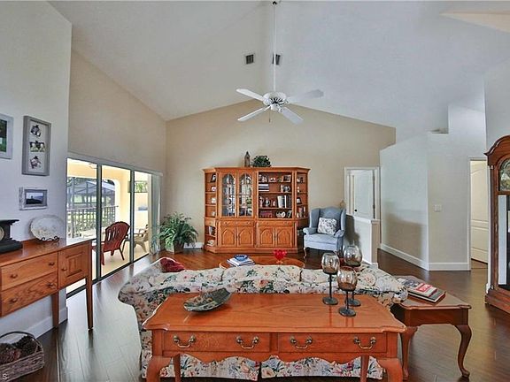 Living Room with view of Lanai and Pool