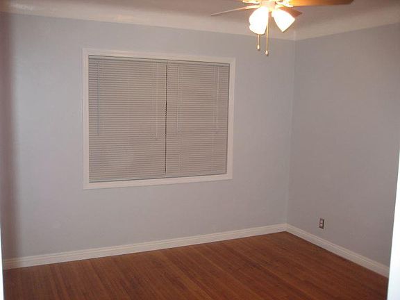 Bedroom with ceiling fan and closet