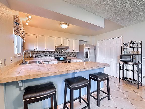 Pantry with double doors & baker's rack with microwave