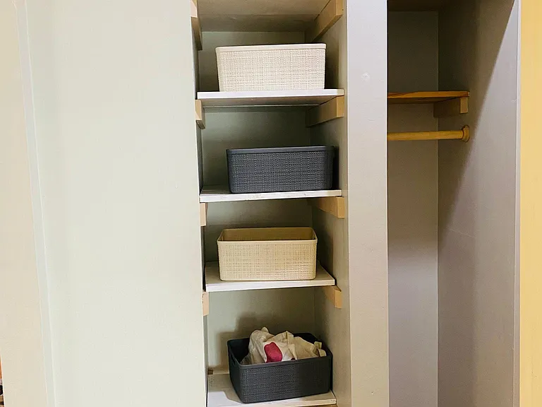 The hall's storage - nook with woven plastic storage bins