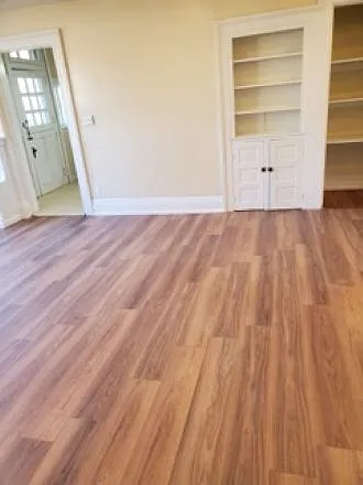 Living room view of built in bookshelf and storage