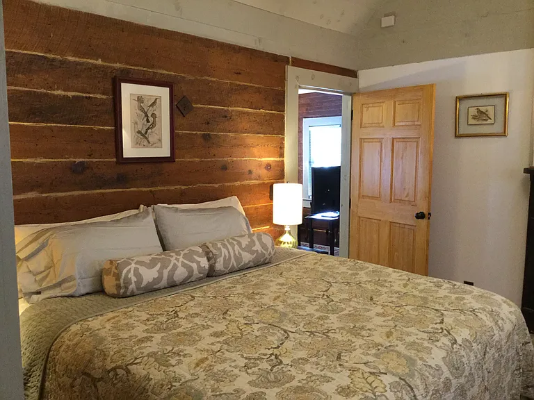 Private primary suite with king bed, ensuite bath, and walk-in dressing room with full-size washer and dryer.