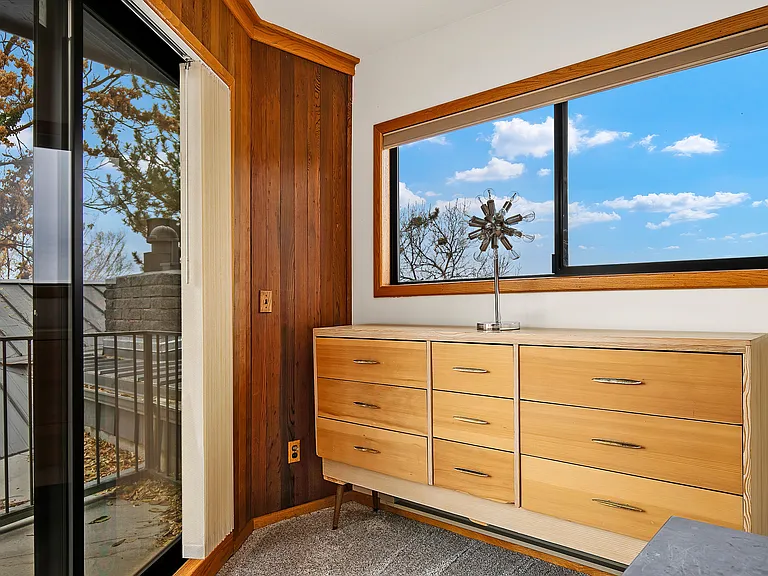 Primary bedroom dresser and private deck.