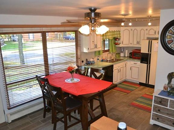 The kitchen and dining room have new ceramic tile flooring that ties the rooms together.  Above the kitchen table is a great picture window giving you a great view of the front yard and tree lined street.