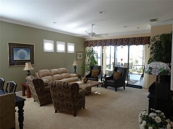 Great room has high ceilings and crown molding.