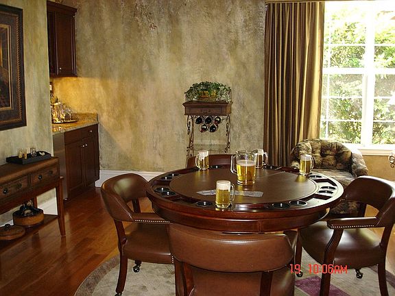 Game room with a complete wet bar and refrigerator