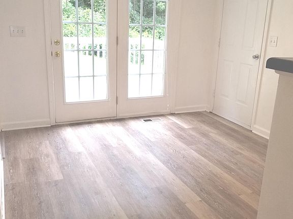 Dining room with new flooring opens onto deck