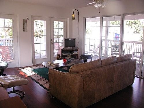 The LR opens up to the porches for entertaining