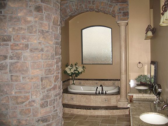 Jetted Tub w/ stacked stone circular snail shower