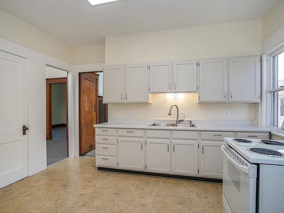 Cheerful Eat-In Kitchen with Ample Cabinet Space, Electric Stove and Pantry