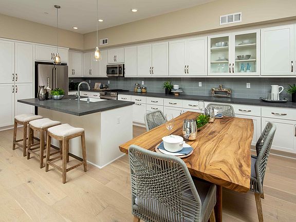 Open-concept floor plan with welcoming kitchen boasting abundant counter space for food prep, centra