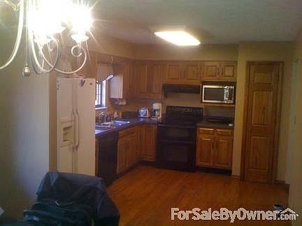 Large Kitchen all in Oak
						:
						Kitchen is done in oak floors and cabinets with door leading to the back deck.
