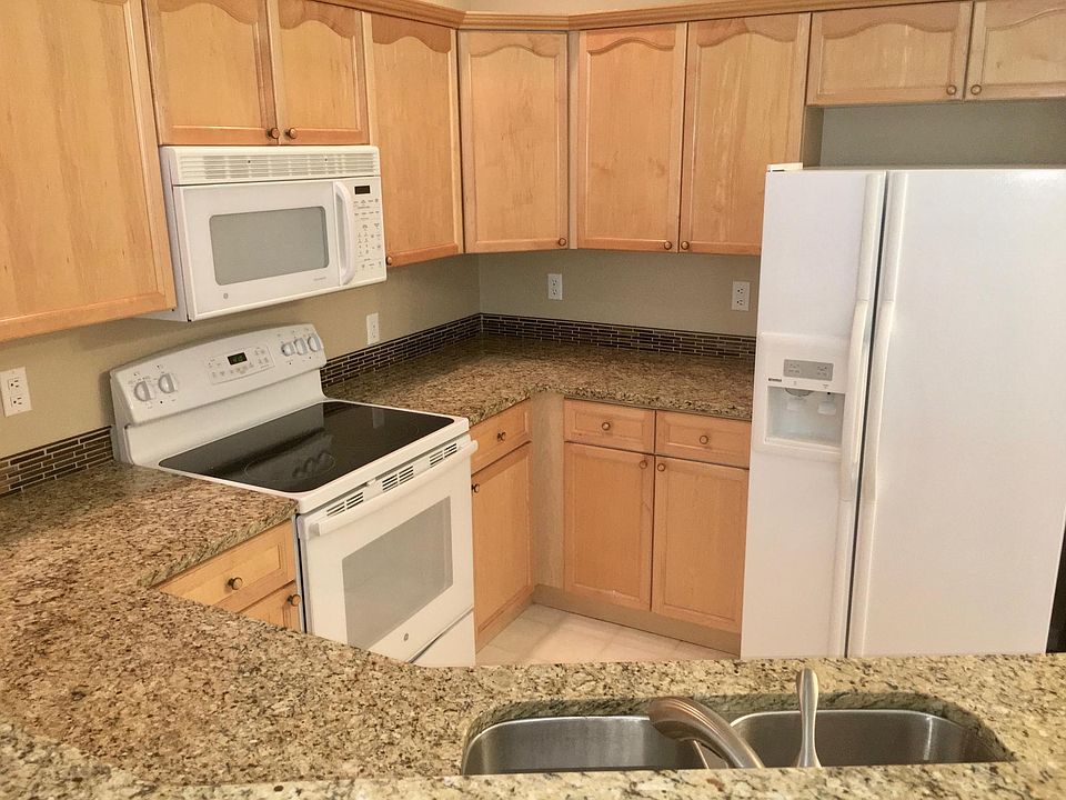 Kitchen with granite countertops, stove, frig, microwave, dishwasher