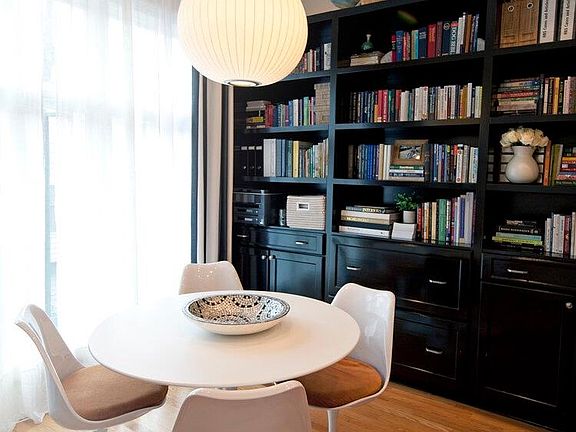 Keeping/breakfast room with custom built-in shelving. Half-