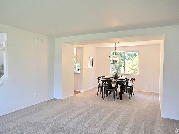 Dining room looks out to lovely, private backyard.