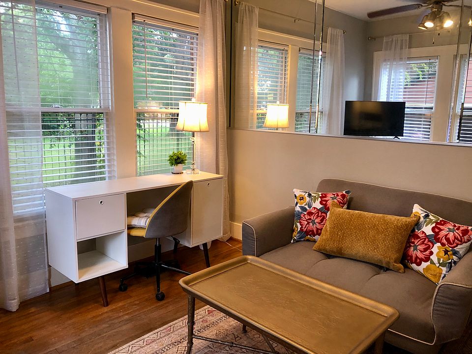 Cozy living space with desk, sleeper sofa, TV and breakfast bar