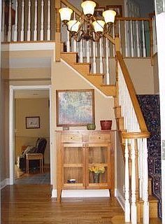 Two story foyer with turned staircase