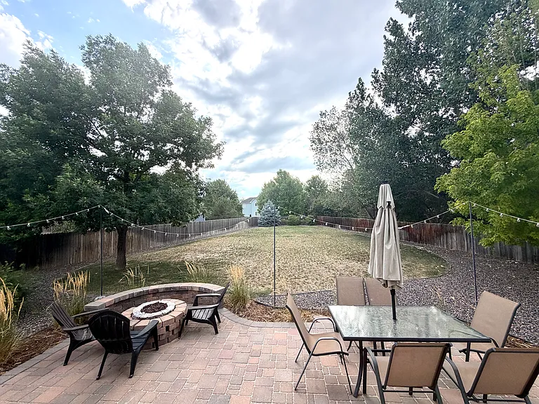 Enjoy the privacy and charm of an expansive backyard surrounded by mature trees. The spacious patio and fire pit create the perfect setting for outdoor entertaining, relaxing evenings, and enjoying the beauty of the seasons.
