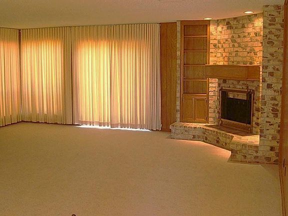 Living room includes Brick Fireplace with Built-In Shelving