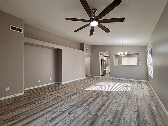 Living & Dining Room. New vinyl plank flooring, paint, ceiling fans and blinds throughout.
