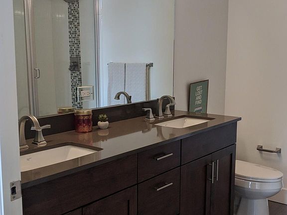 Master bathroom with dual sinks and separate shower and tub