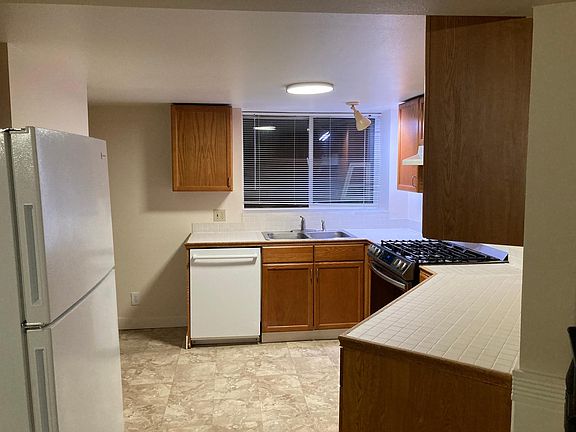 Kitchen with new flooring, gas stove, refrigerator. Plenty of cabinet space. Bosch dishwasher.