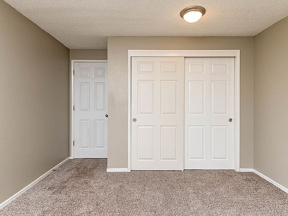 Spacious Bedroom with Closet and Light Brown Carpet