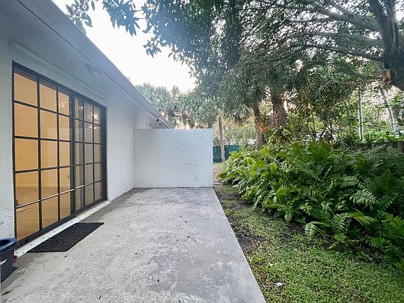 Large Patio out living room sliding door, into tropical garden setting