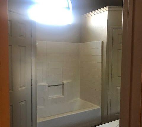 Master bath. His/Her closets on each side of tub