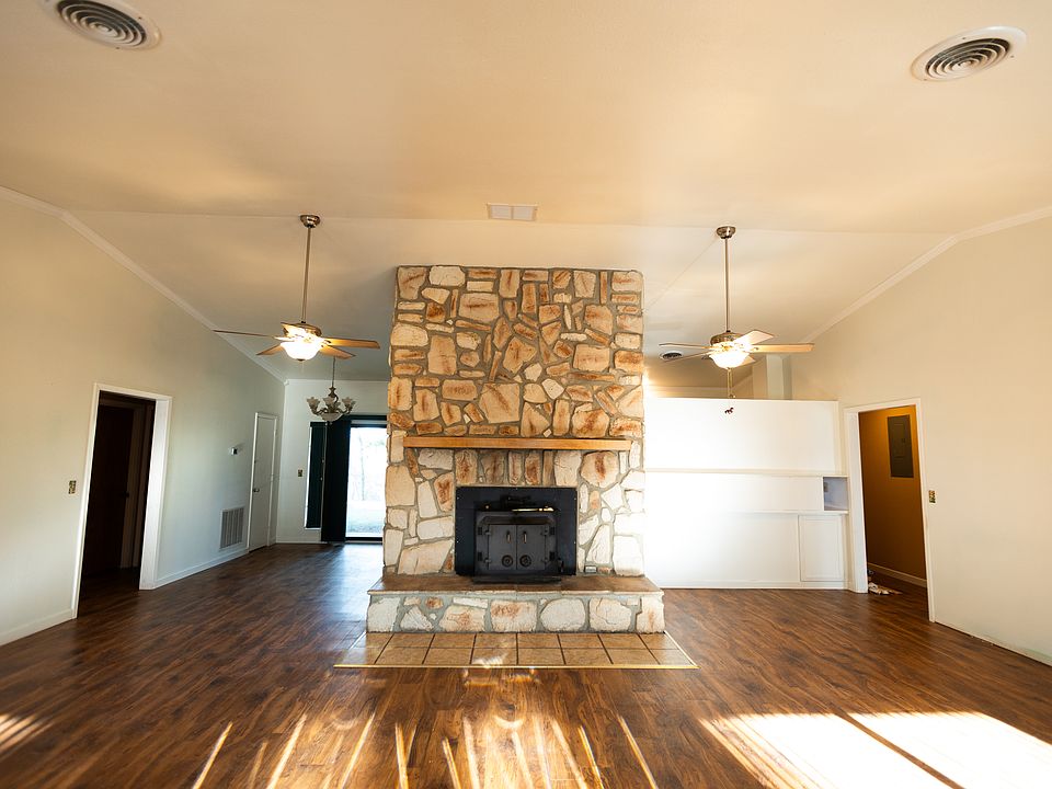 Vaulted ceilings living space upon entry with real stone fireplace.