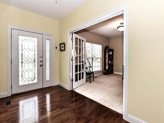 Entry foyer with gleaming hardwood.