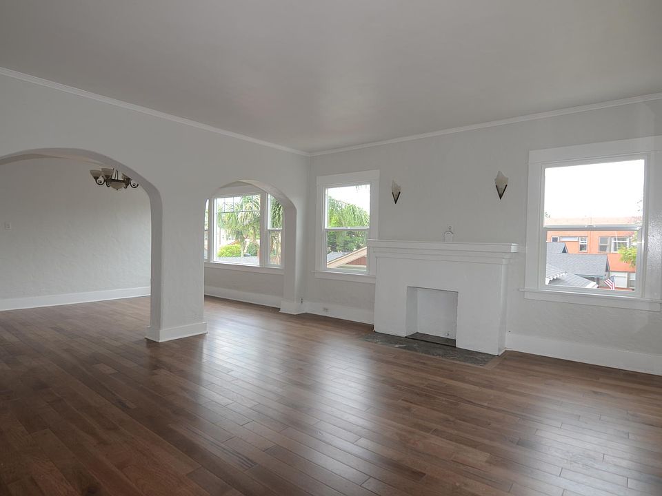 Living room to dining room with brand new solid hardwood floors and brand new high efficiency windows.