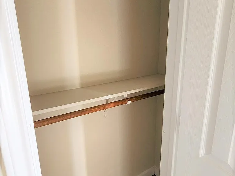 Other closet has two bars for maximum storage space.