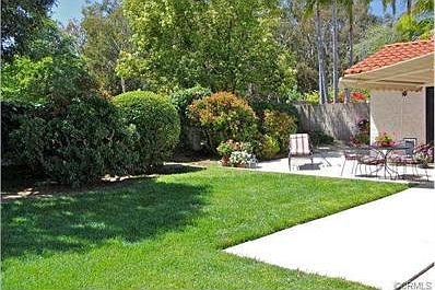 Large, private backyard with colorful plantings and an inviting