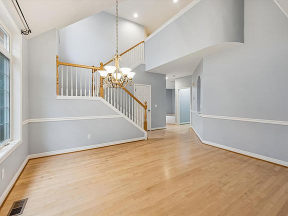 View of formal dining w/ hall entrance into kitchen/living