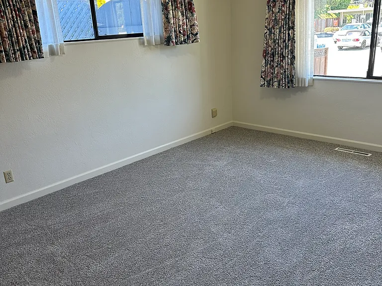 Primary bedroom with lots of light. All-new carpets/paint throughout the house. Lots of light and a view of the third front parking area (includes EV/RV power)