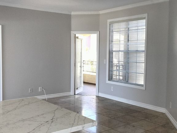 View from dining area past central bar/entertaining area in ktichen looking towards living to patio door.
