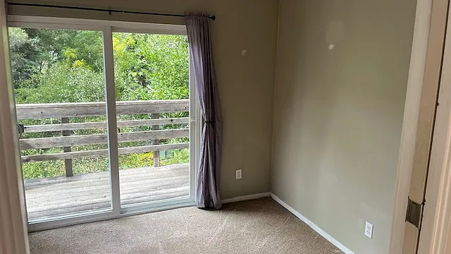one of the bedrooms with shades and drapery included opens to small deck with sliding glass doors