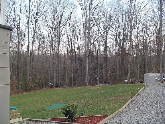 side view of rear yard and woods